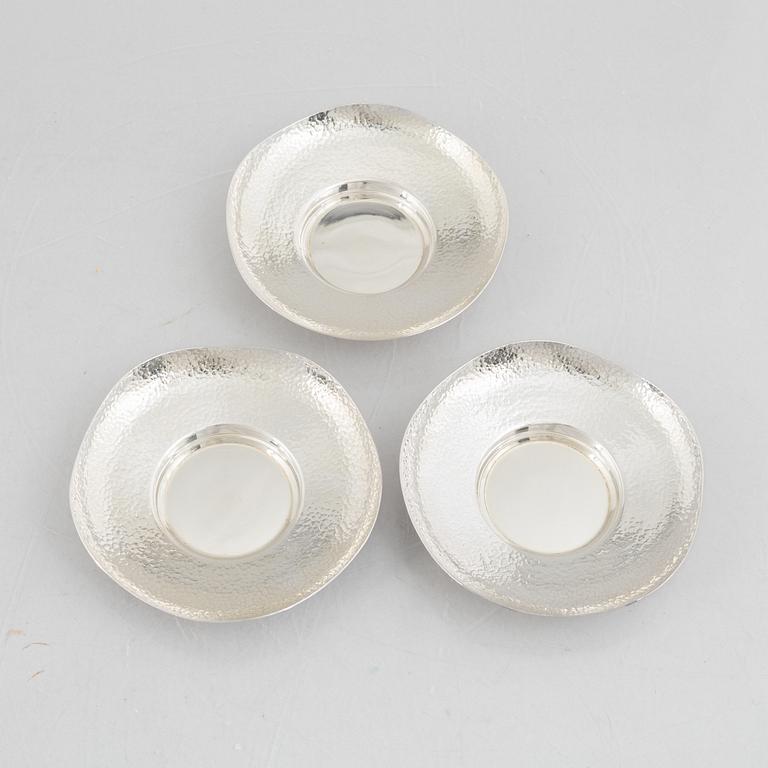 A set of three Japanese silver coasters and a pair of salts with shakers, 20th century.