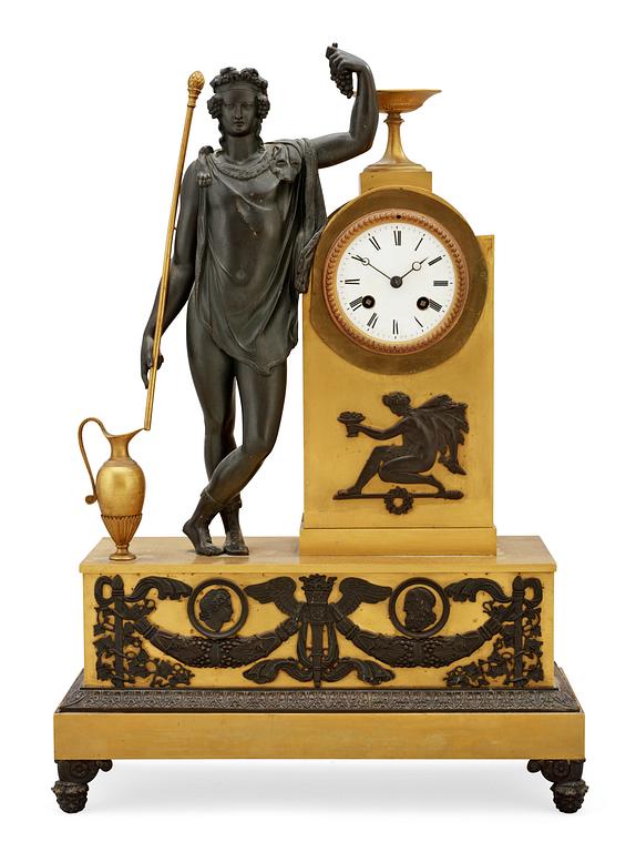 An Empire early 19th Century gilt and patinated bronze mantel clock.