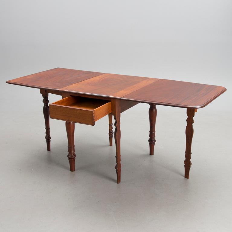 A 19th-20th Century drop leaf table.