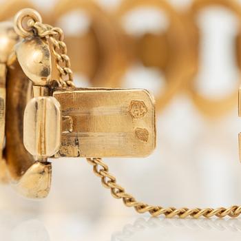 Arm bracelet, 18K gold, decoration of flowers.