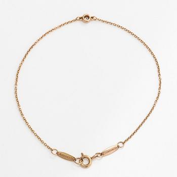 Tiffany & Co, an 18K gold 'Diamonds by the Yard' bracelet with a brilliant-cut diamond.