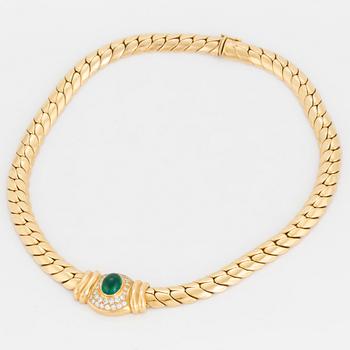 A necklace set with an oval, cabochon-cut emerald and round, brilliant-cut diamonds.