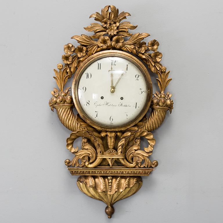 A late Gustavian gilt wood wall clock by Ephraim Hedström (active 1808-1818), Stockholm.