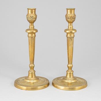 A pair of late 18th century bronze candlesticks.
