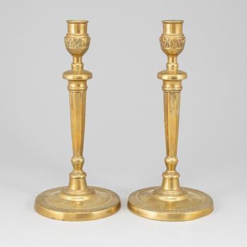 A pair of late 18th century bronze candlesticks.