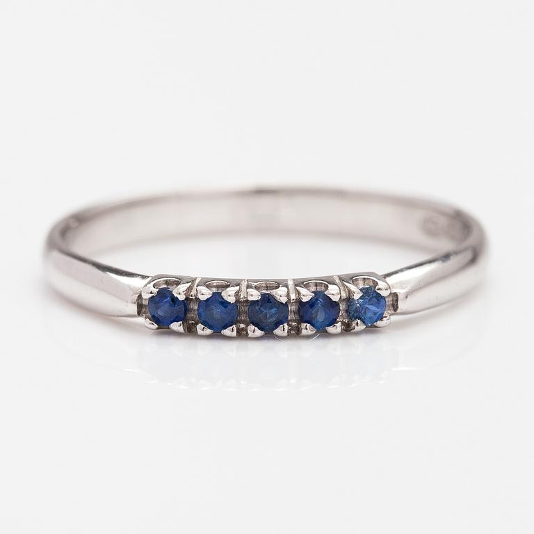 A 14K white gold ring with sapphires.