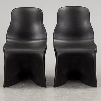 a pair of Italian black plastic chairs designed by Fabio Novembre "Him" and "Her" from the late 20th Century.