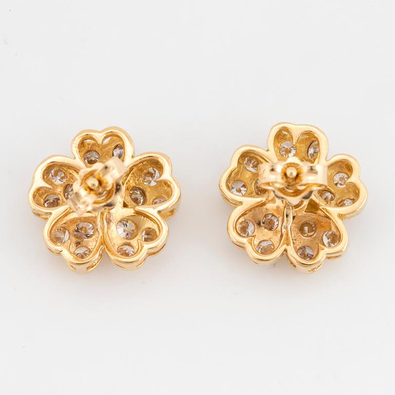 Brilliant-cut diamond flower earrings.