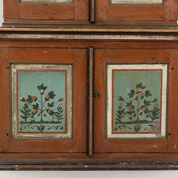 A Swedish polychrome.-painted cabinet, presumably from Halland, dated 1805.