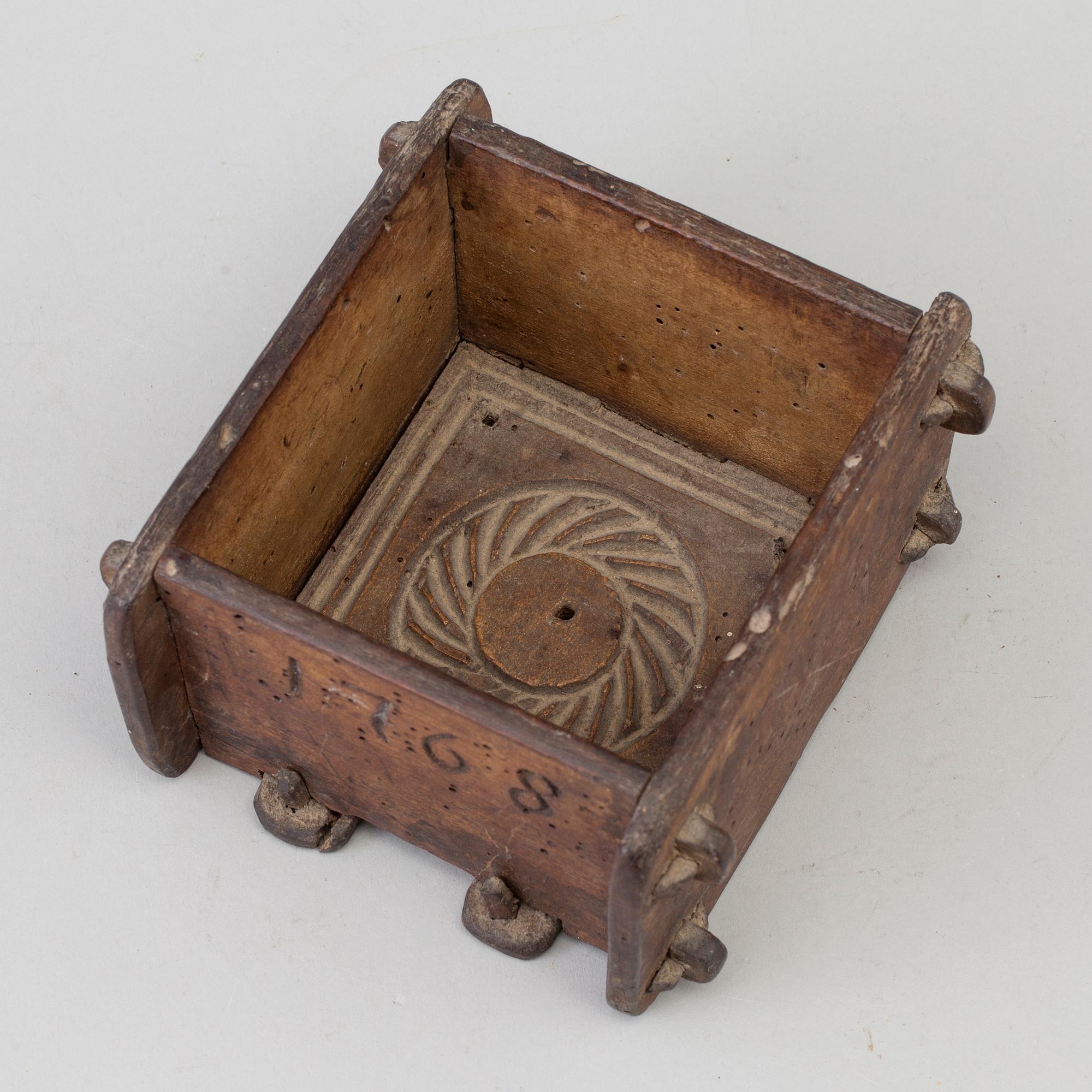 A cheese mould, dated 1768.
