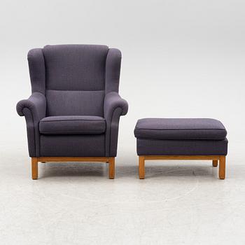 An armchair with foot stool, Norell Möbler AB, Sweden, late 20th century.