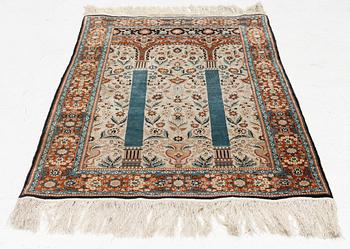 An oriental silk rug, c. 154 x 93 cm.