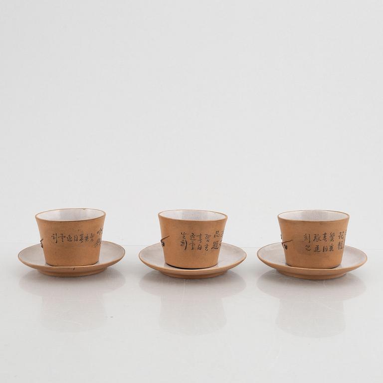 Three Yixing cups with saucers and a bowl, china, early 20th century.