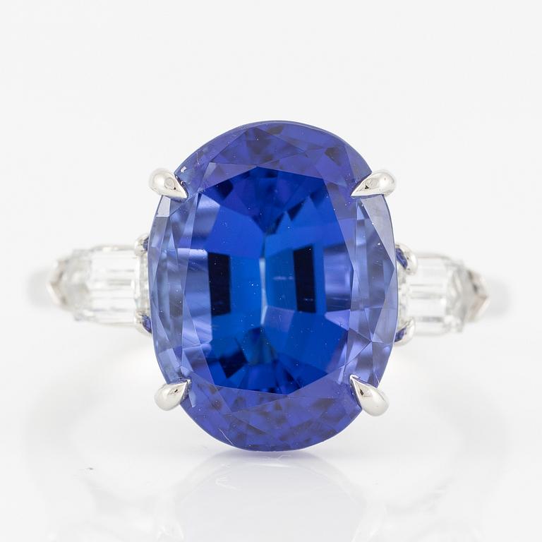 Ring, Fred Leighton platinum with an oval faceted tanzanite and fancy-cut diamonds.