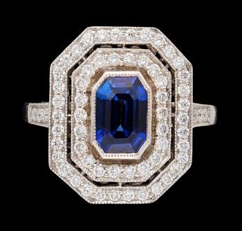 677. A gold blue sapphire and diamond ring.