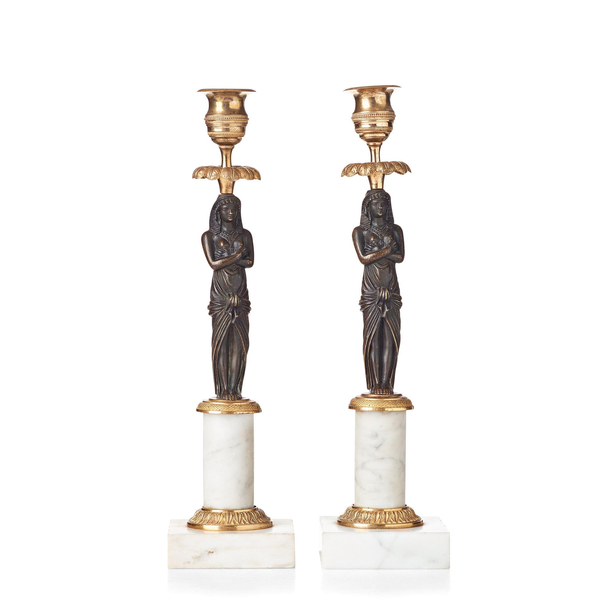 A pair of late Gustavian circa 1800 white marble and bronze candlesticks.