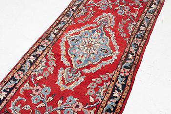 An oriental runner carpet, c. 550 x 75 cm.