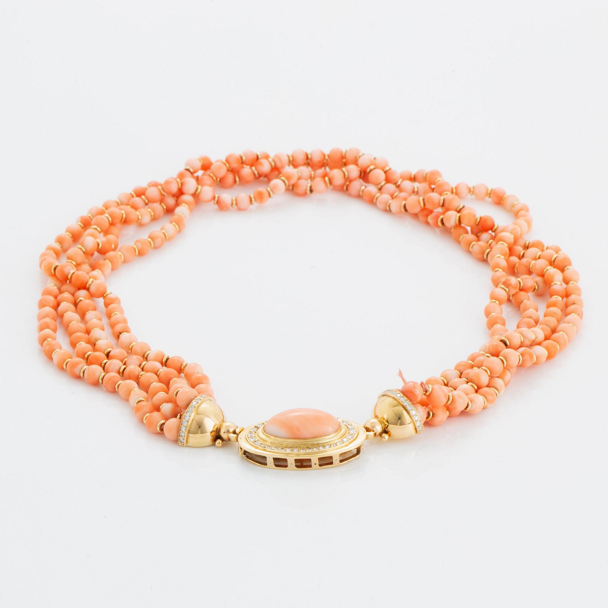 A four strand coral necklace with an 18K gold clasp set with coral and round brilliant-cut diamonds.