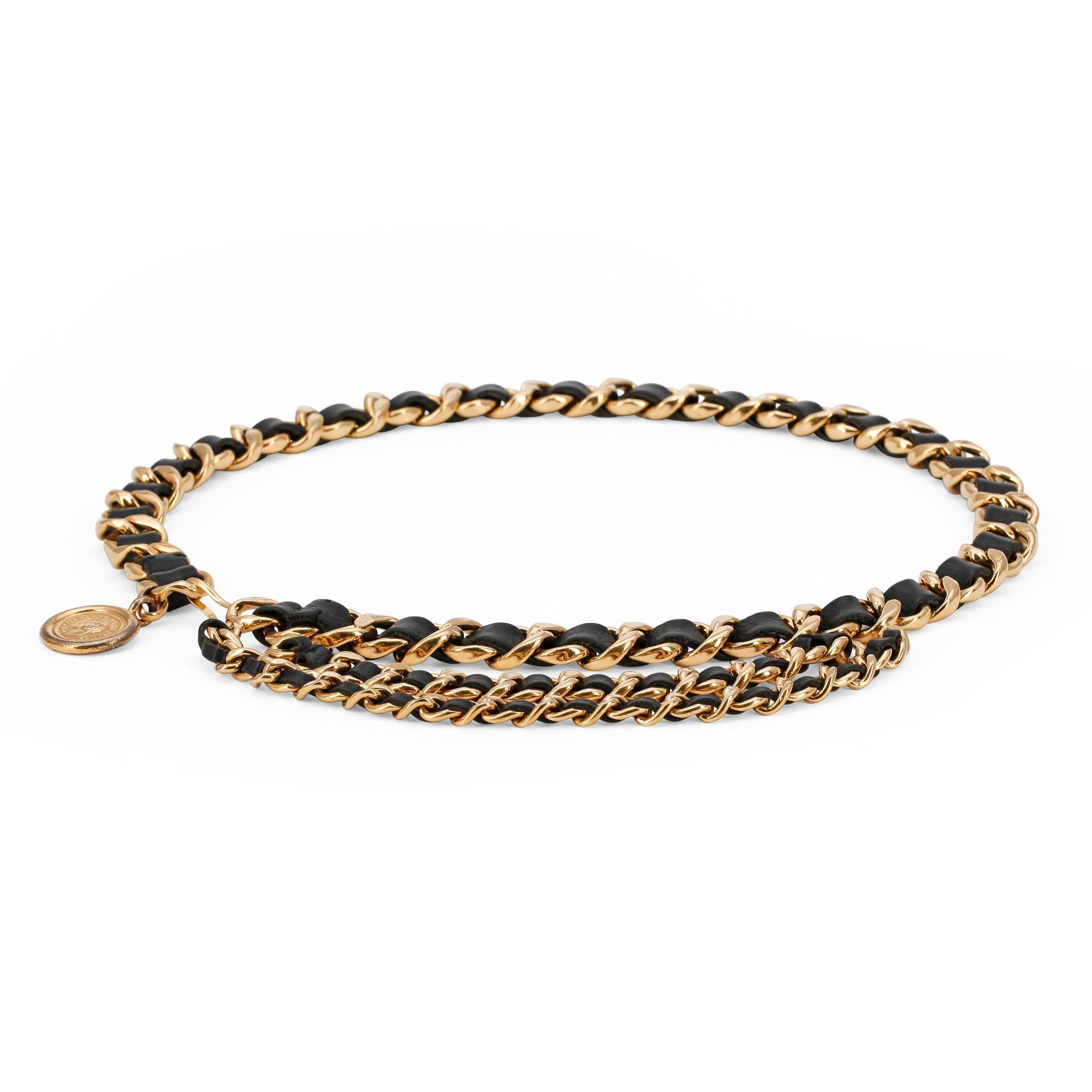 CHANEL, a black leather and gold colored chain belt.