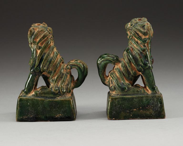 A pair of green glazed figures of 'Buddhist Lions', Ming dynasty.