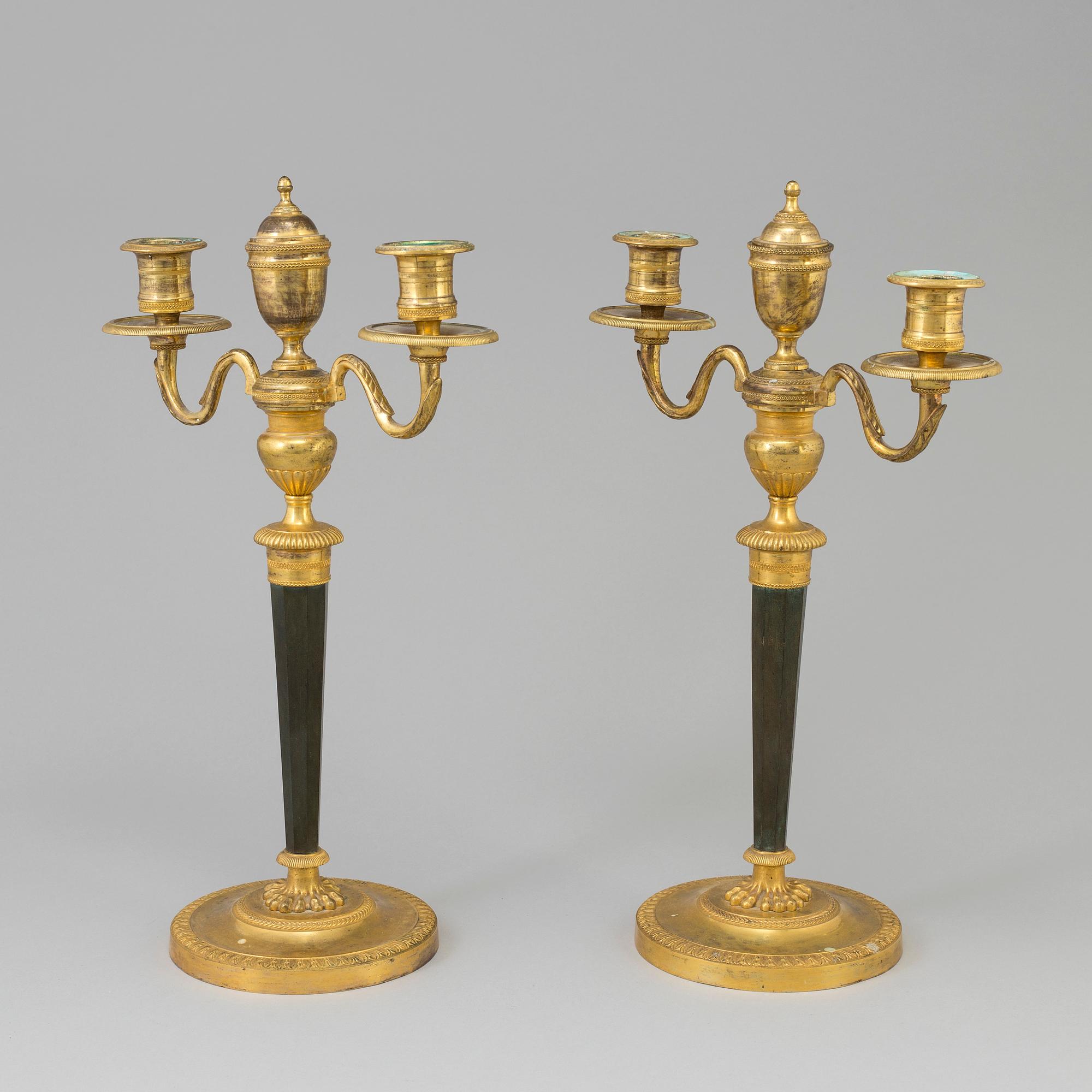 A pair of French Directoire late 18th century ormolu candelabra for three candles.