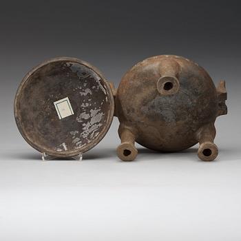 A pottery tripod censer, Han dynasty (206 B.C. -220 A.D.).