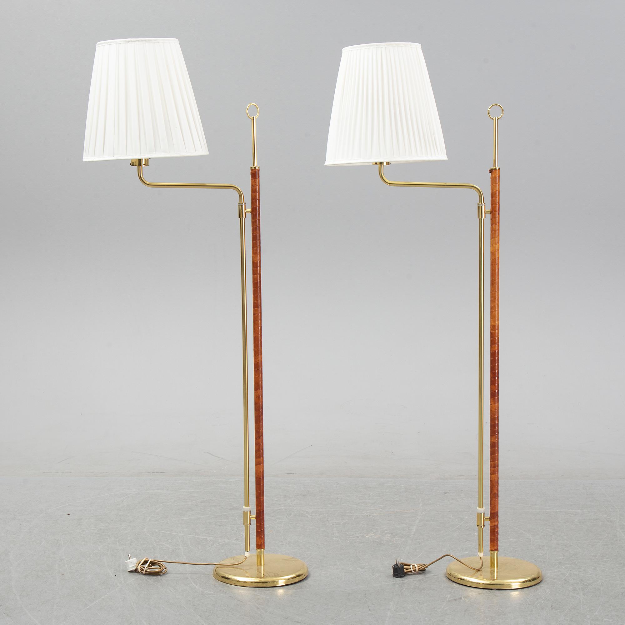 A pair of brass and leather floor lights, Örsjö Industri, 21st century.