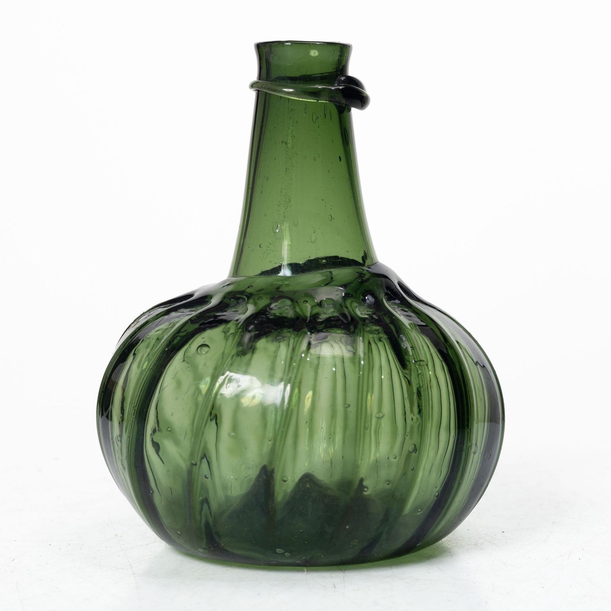 A green twisted glass bottle, 18th century.
