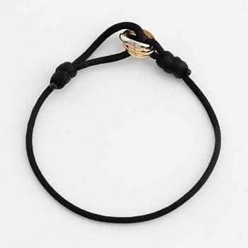 A Cartier "Trinity" bracelet, 18K three colour gold and textile.