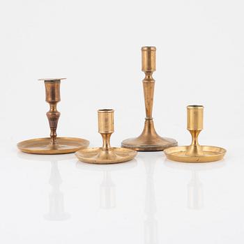 Four brass candlesticks, 18th-19th Century.