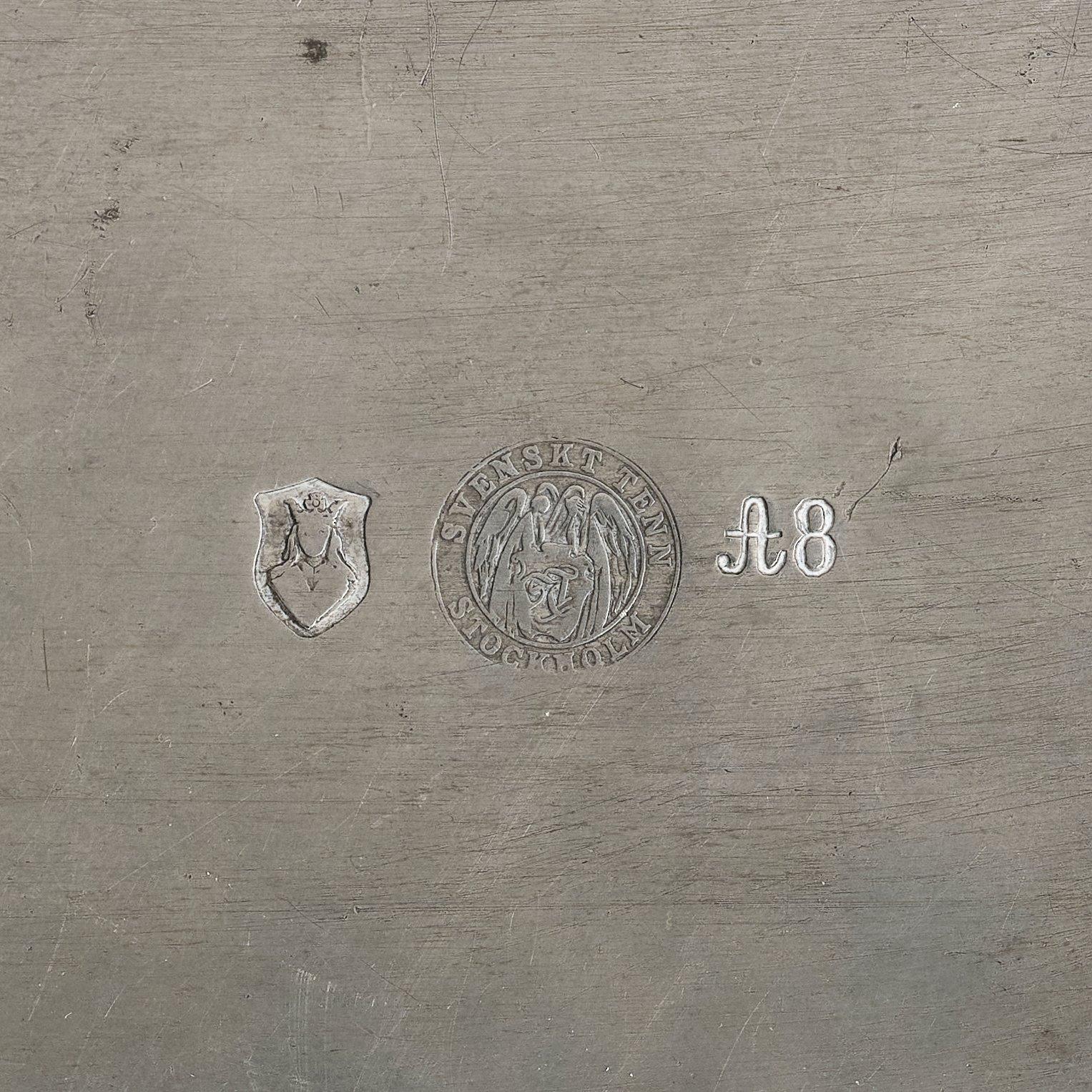 Firma Svenskt Tenn, a pewter matchbox case with beaker, models "38d" and "185a", with decor by Anna Petrus, Stockholm 1927-28.