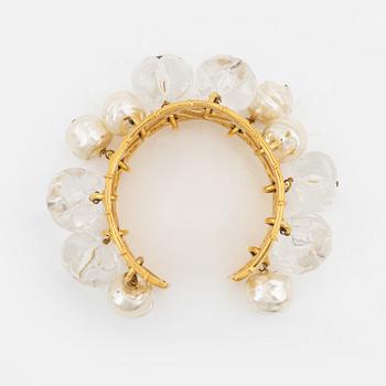 Céline, a gold tone bracelet.