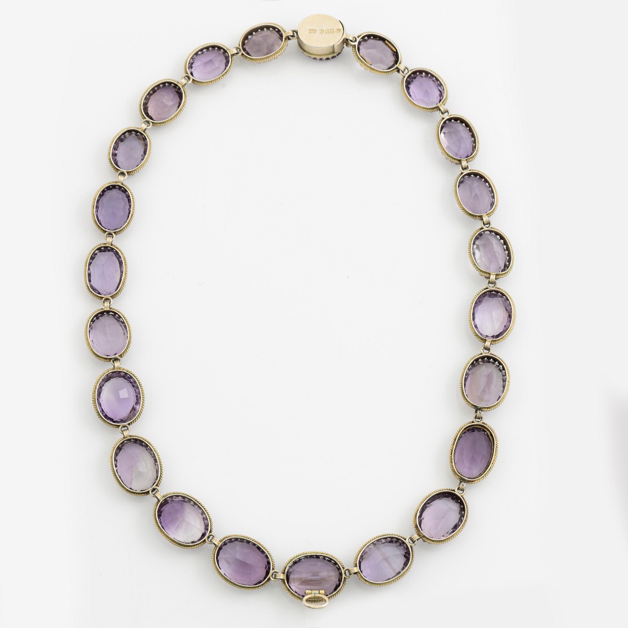 Garniture, necklace and bracelet silver with amethysts, brooch gold-coloured metal with purple paste stones,