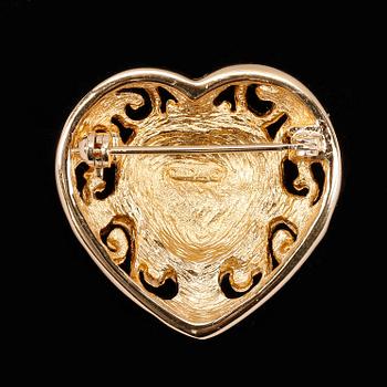 A heart-shaped golden brooch by Christian Dior.