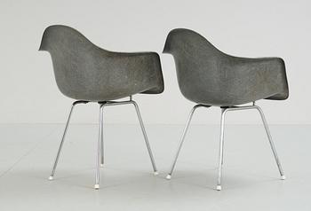 A pair of plastic chairs by Charles and Ray Eames.