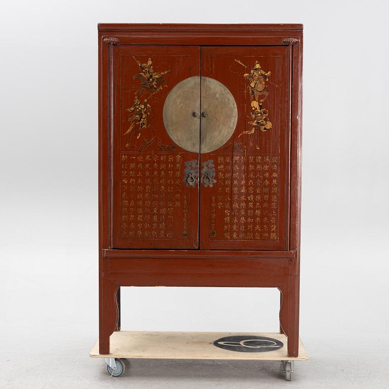 A red lacquered cabinet, China, early 20th century.