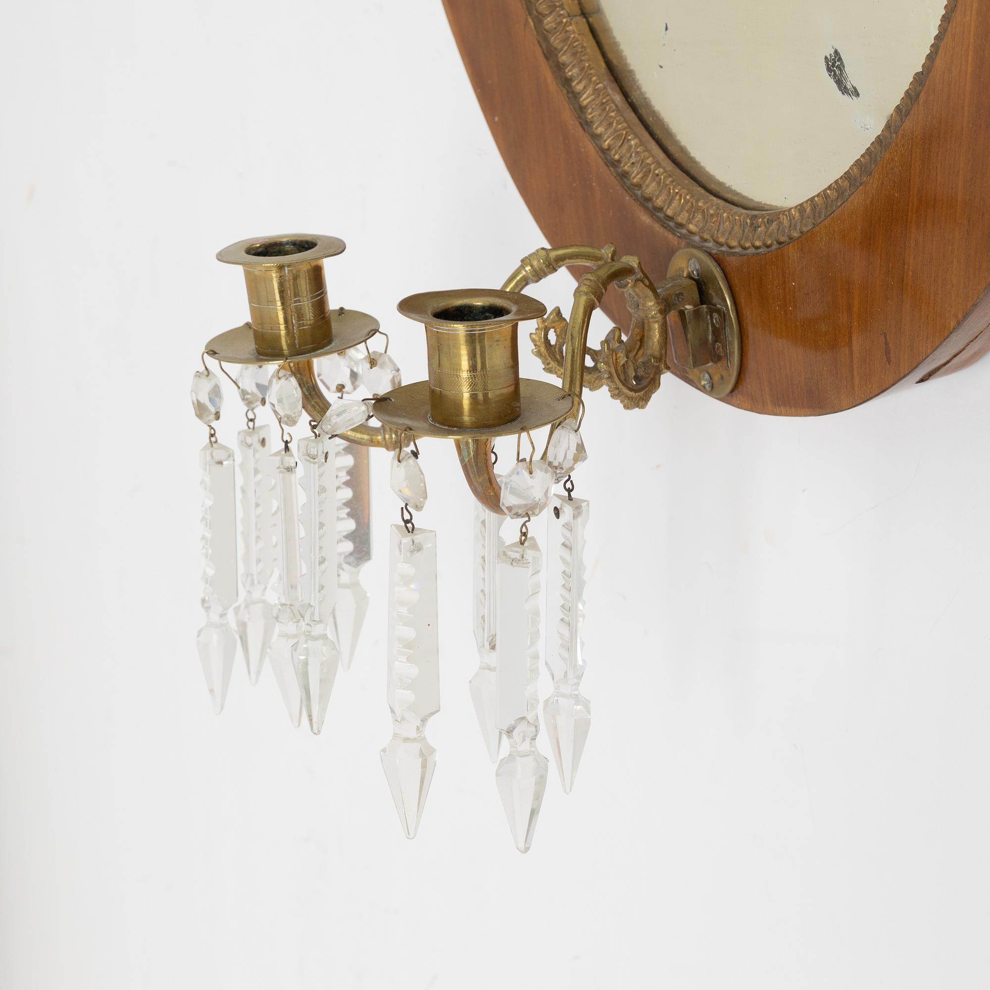 A mahogany veneered mirror sconce, Empire style, around 1900.