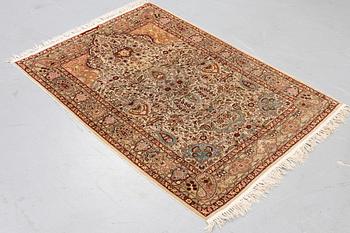 A rug, Old silk Hereke, ca 152 x 110 cm.