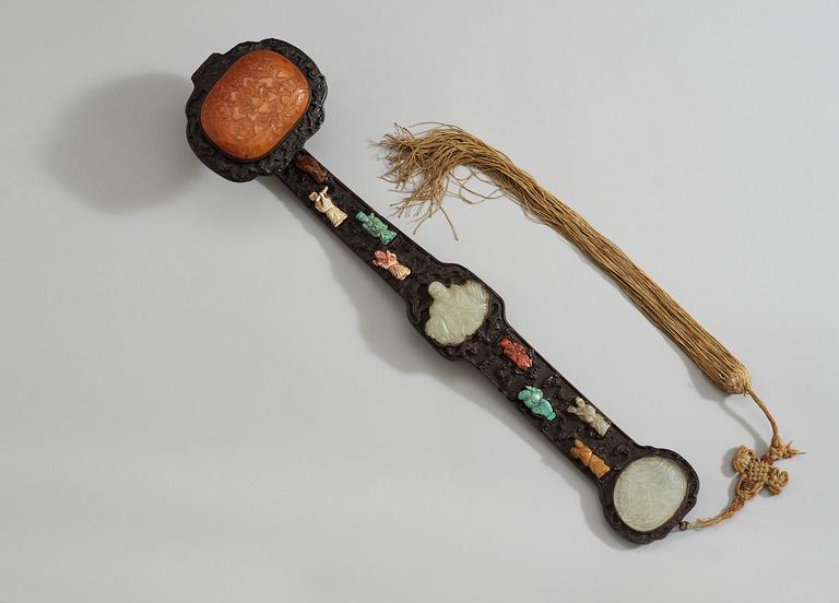 A hardwood Ruyi Sceptre with inlays of nephrite, turquoise, coral and other materials. Qing dynasty, presumably Qianlong.