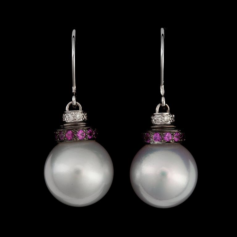 A pair of cultured South Sea pearl and ruby earrings.