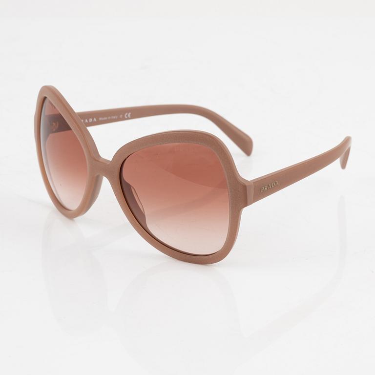 Prada, a pair of coral pink color sunglasses.