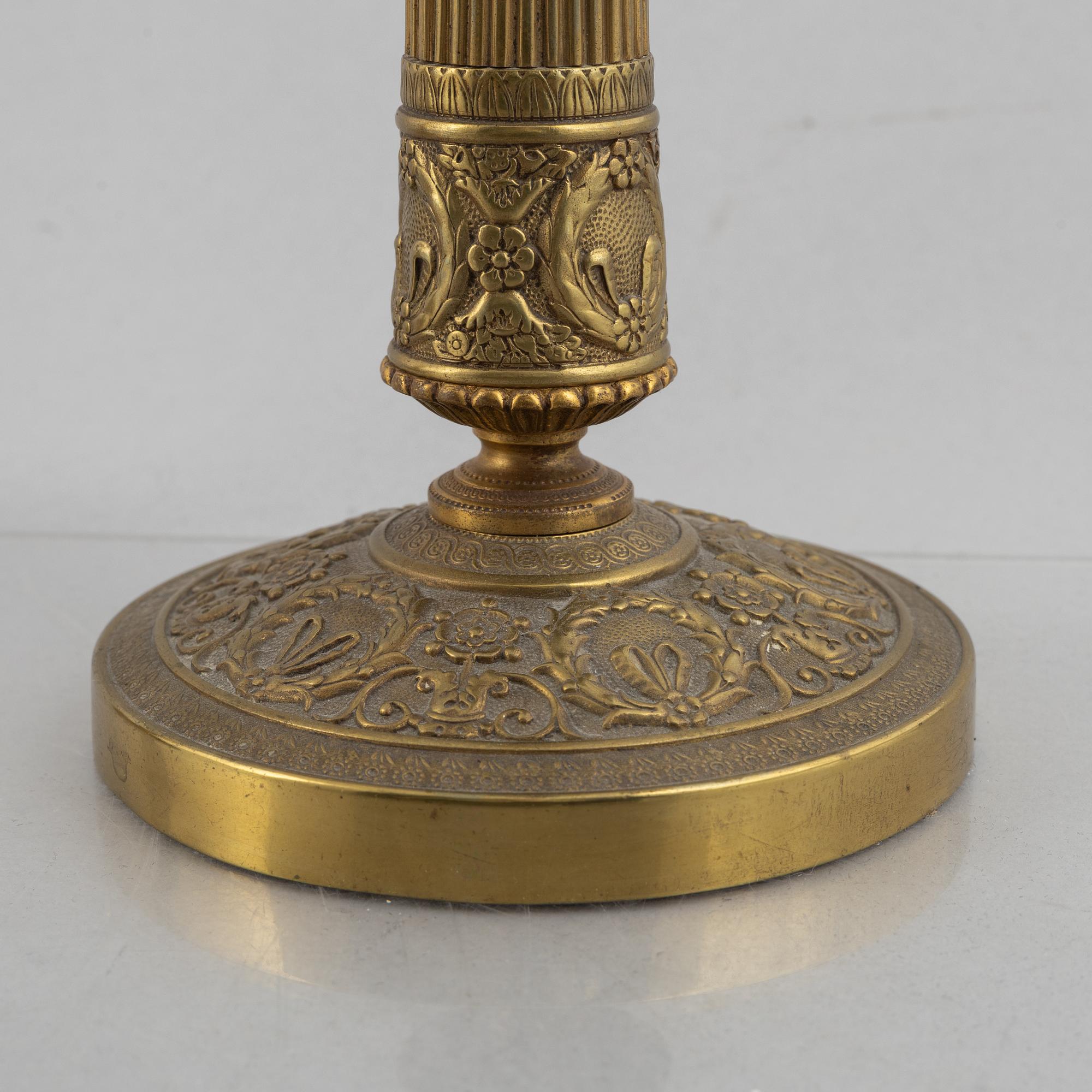 A pair of Empire gilt brass candle sticks, first half of the 20th century.