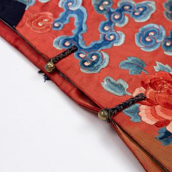 An embroidered red ground five clawed dragon 'female' formal robe, Qing dynasty, 19th century.