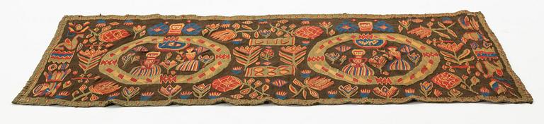 A carriage cushion, "the Annunciation", tapestry weave, ca 103 x 51 cm, south western Scania (Sweden), 1833.