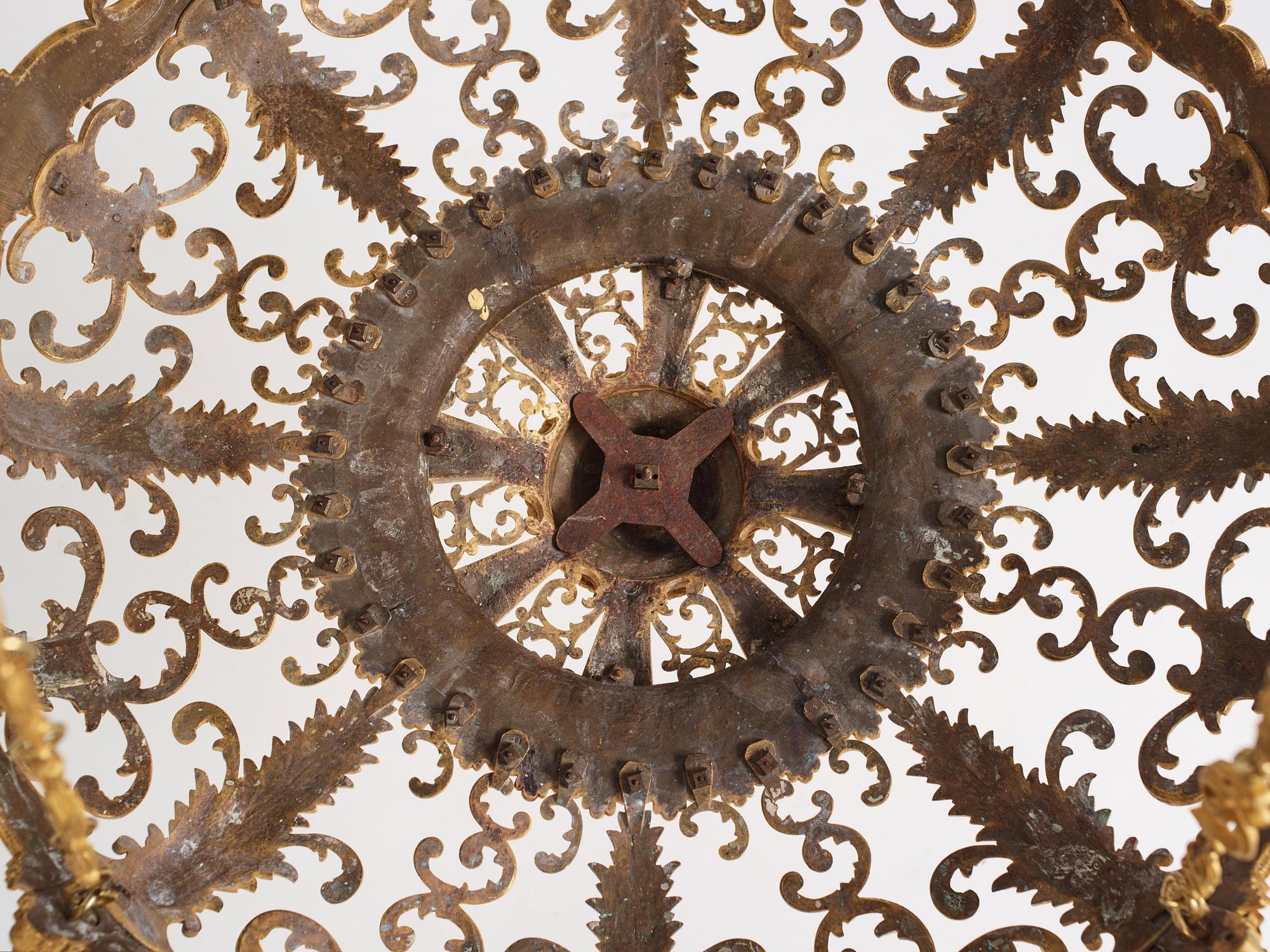 A rococo-revival gilt-brass sixteen-light chandelier, mid 19th century.