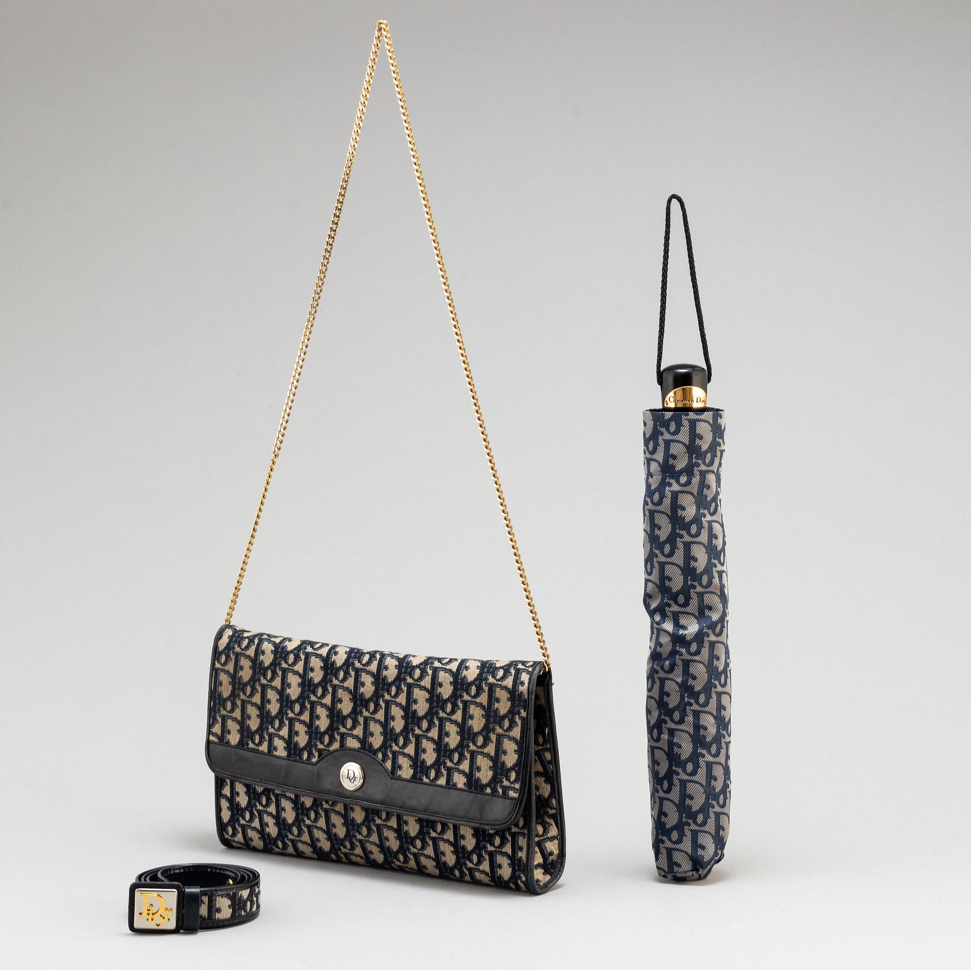 CHRISTIAN DIOR, a set of a clutch, a belt and an umbrella.