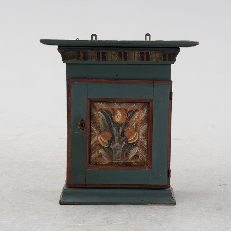 A painted wall cabinet.