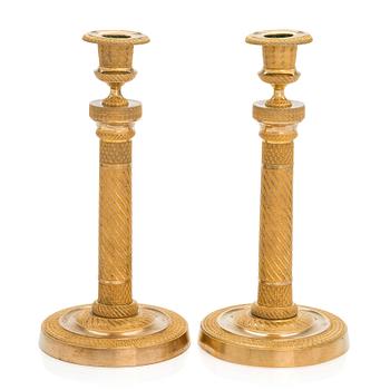 A pair of  French gilded Empire candlesticks, early 19th century.