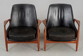 A pair of Ib Kofod Larsen 'Sälen' teak and black leather easy chairs by Olof Person, Jönköping, Sweden.