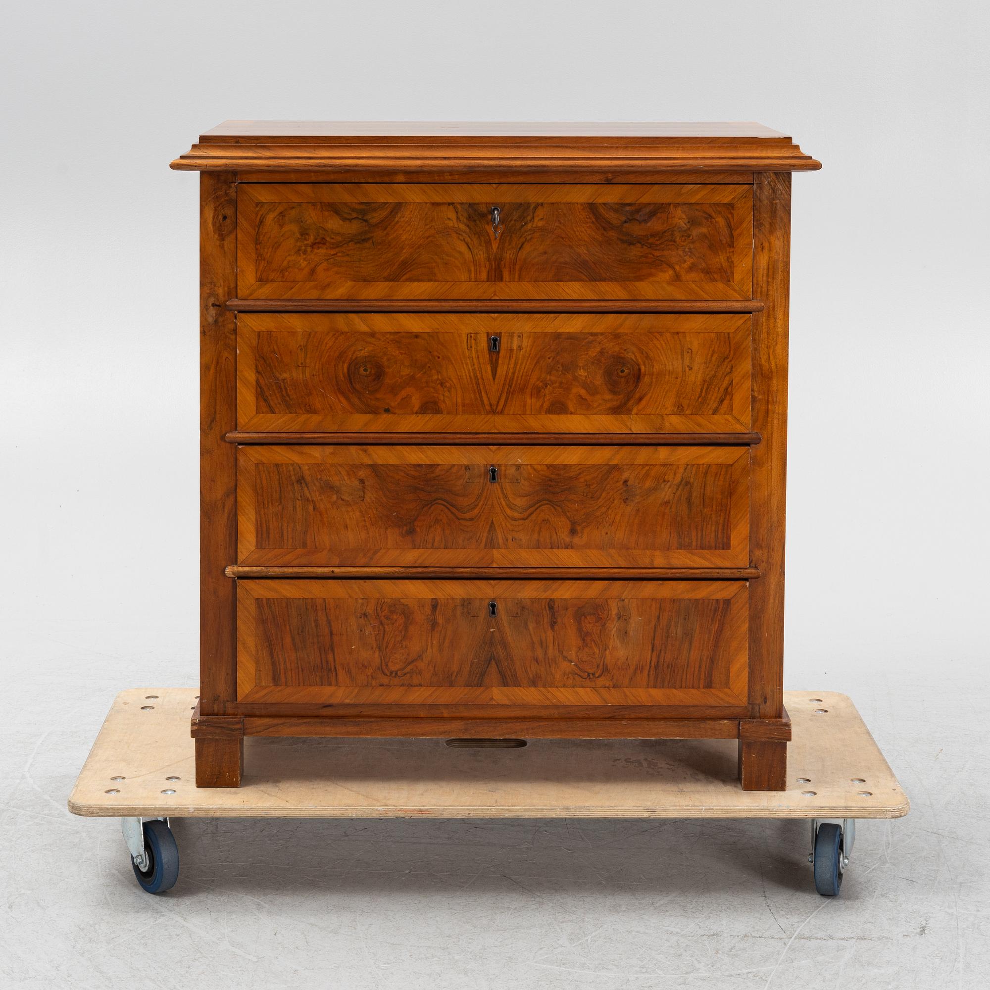 A walnut-veneered dresser, around 1900.